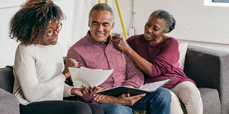 Couple reviewing documents with advisor