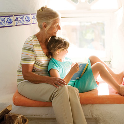 Grandmother and granddaughter reading a book